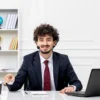 customer-service-handsome-young-guy-office-suit-with-laptop-headset-pointing-coffee-cup